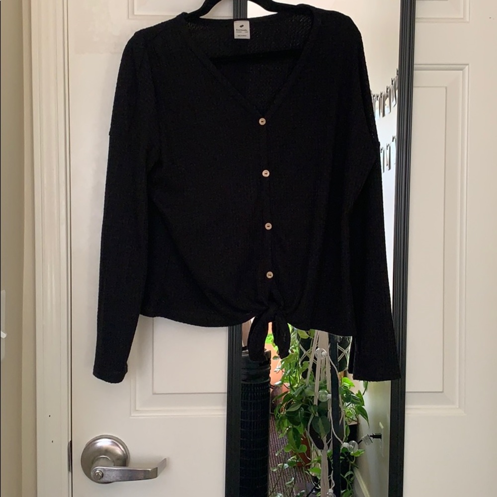 Black sweater with buttons and a tie
